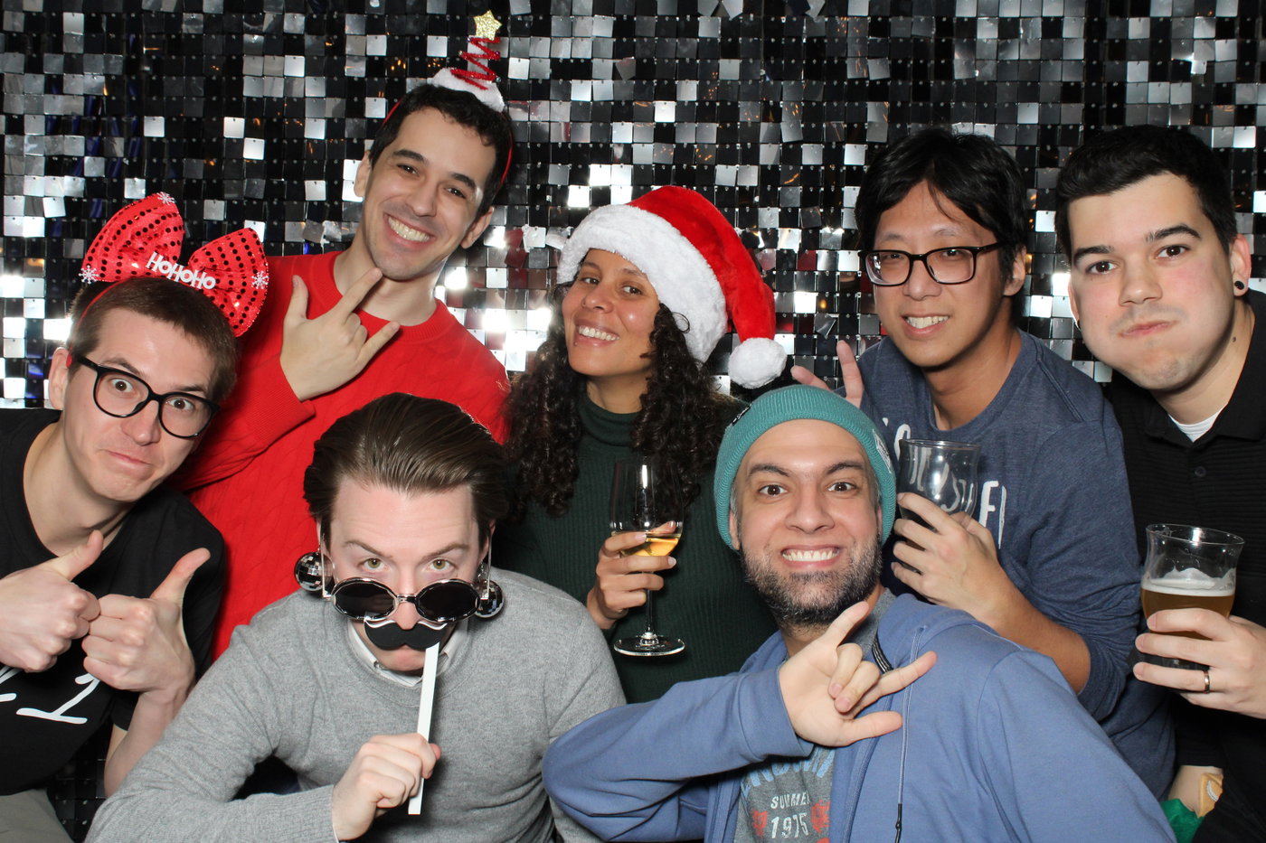 Colleagues in Santa hats and silly glasses at the ASE and SWE Holiday Lunch