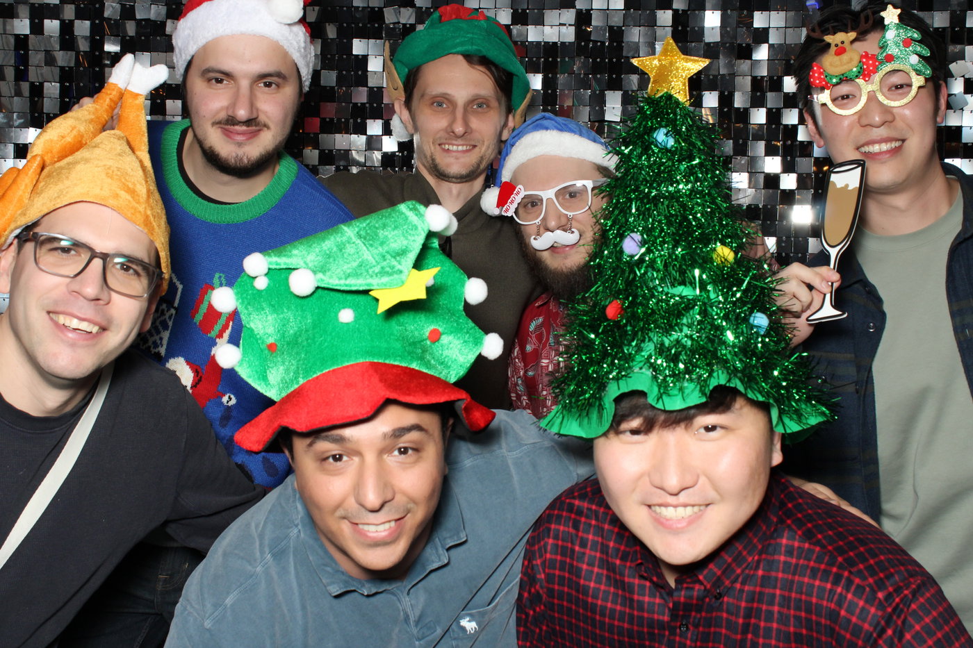 Friends in giant Christmas tree hats at the ASE and SWE Holiday Lunch
