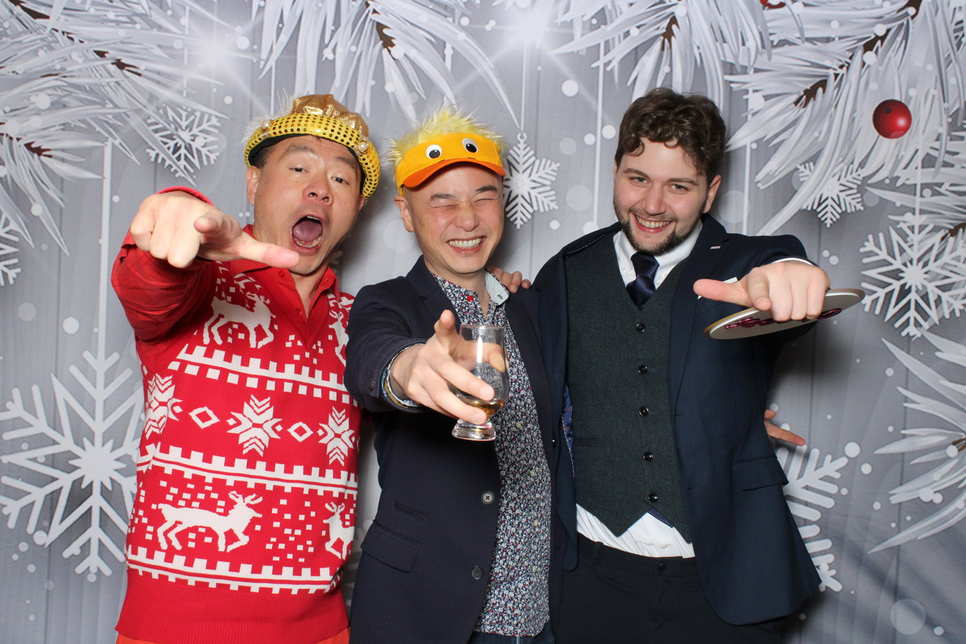 Three Collabware guests in festive hats striking a pose