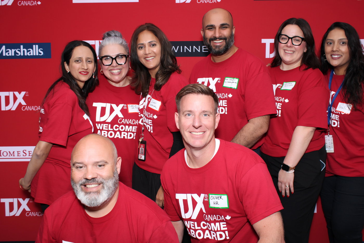 A TJX Canada crew in Welcome Aboard tees smiling at the photo booth